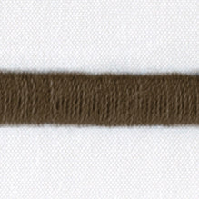 Close-up of walnut woven trim detail on white linen duvet cover.
