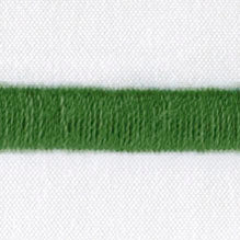 Close-up of forest green fringe trim detail on white linen fabric.