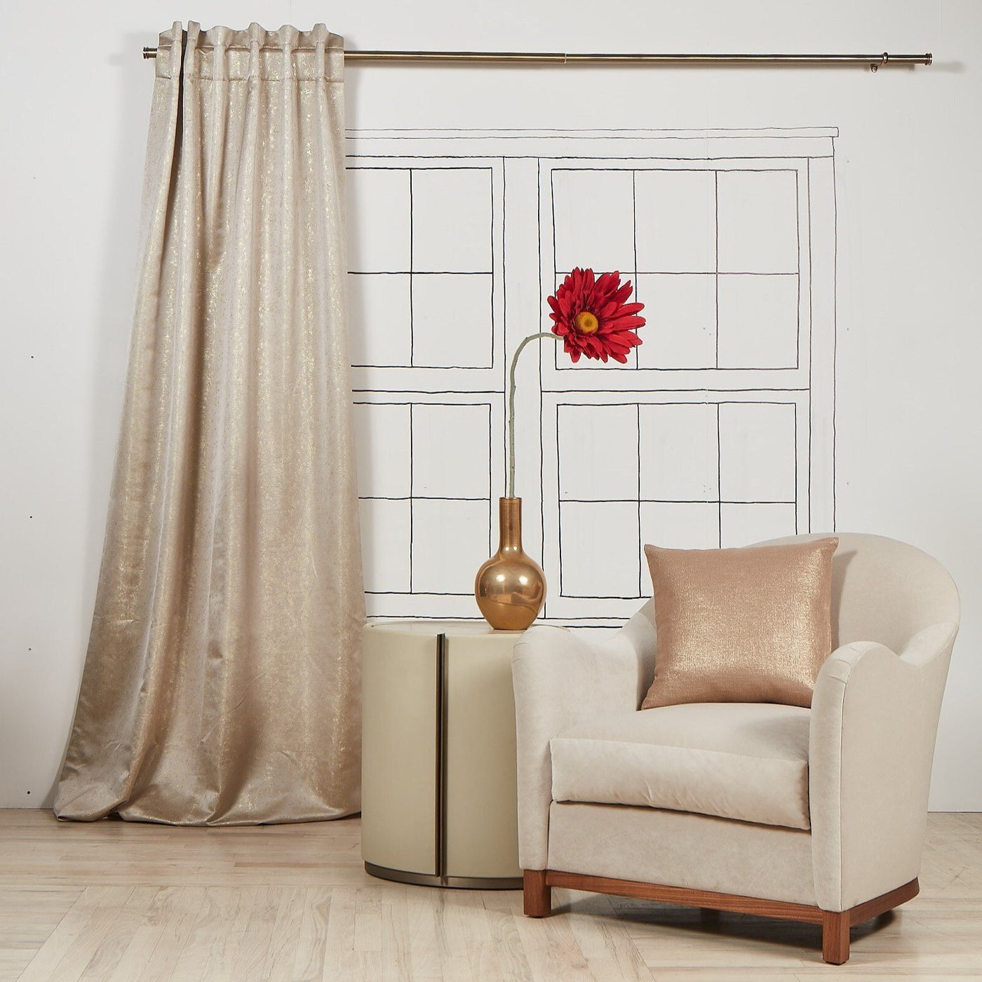Ann Gish Aura curtain panel in champagne, styled beside armchair with matching cushion.
