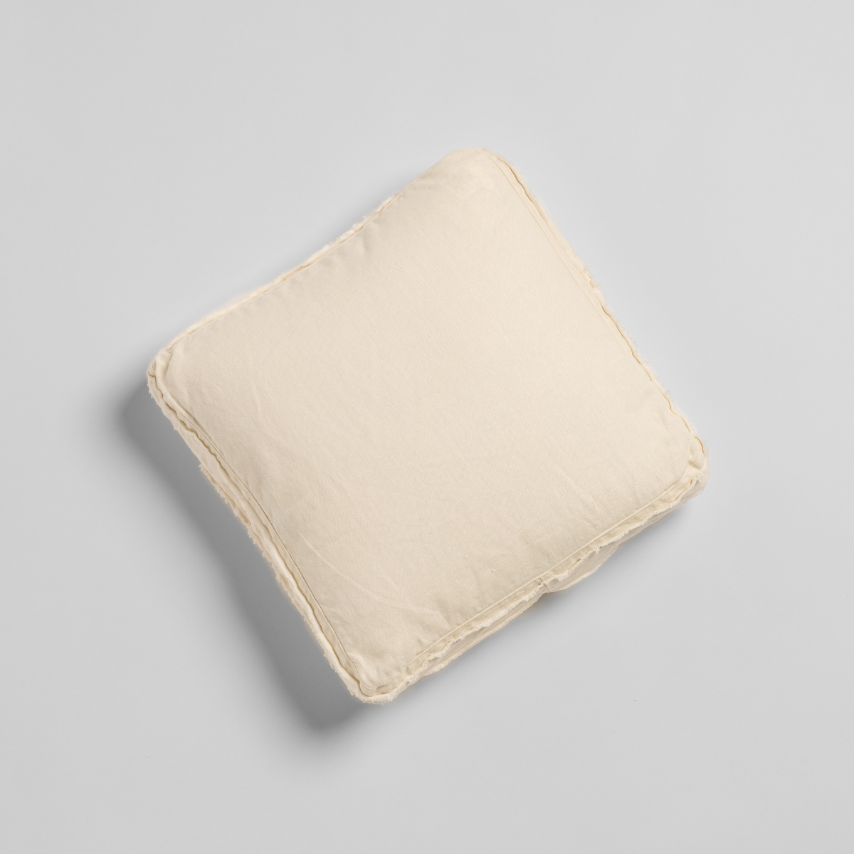 Bella Notte Austin throw pillow in Natural, shown from above with ruffled trim detail.