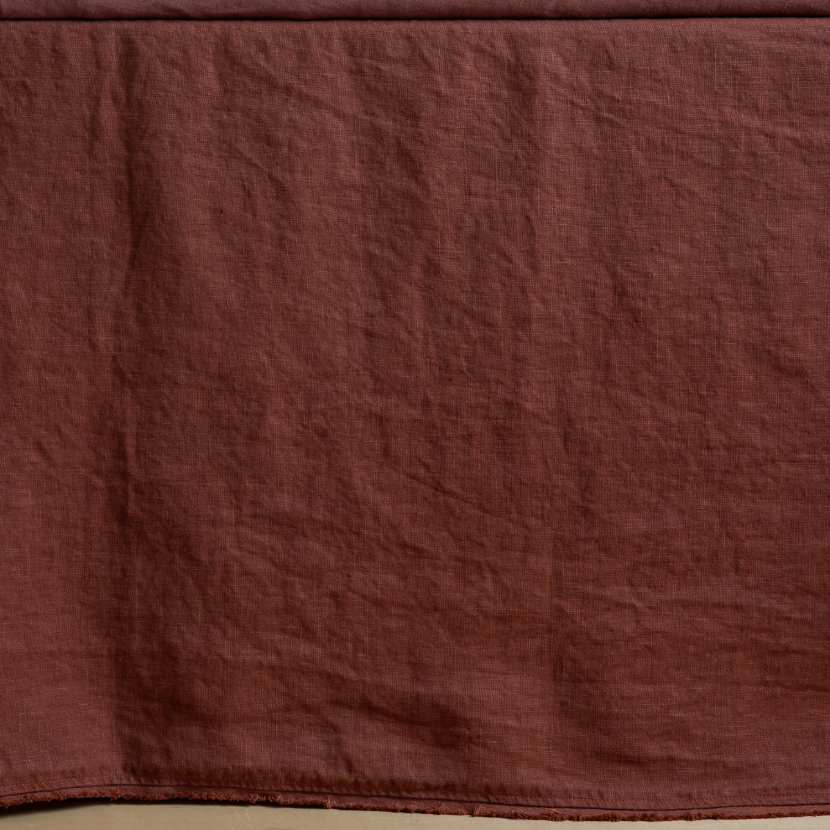 Bella Notte Austin bed skirt in Autumn, close view of hemline and washed linen texture.