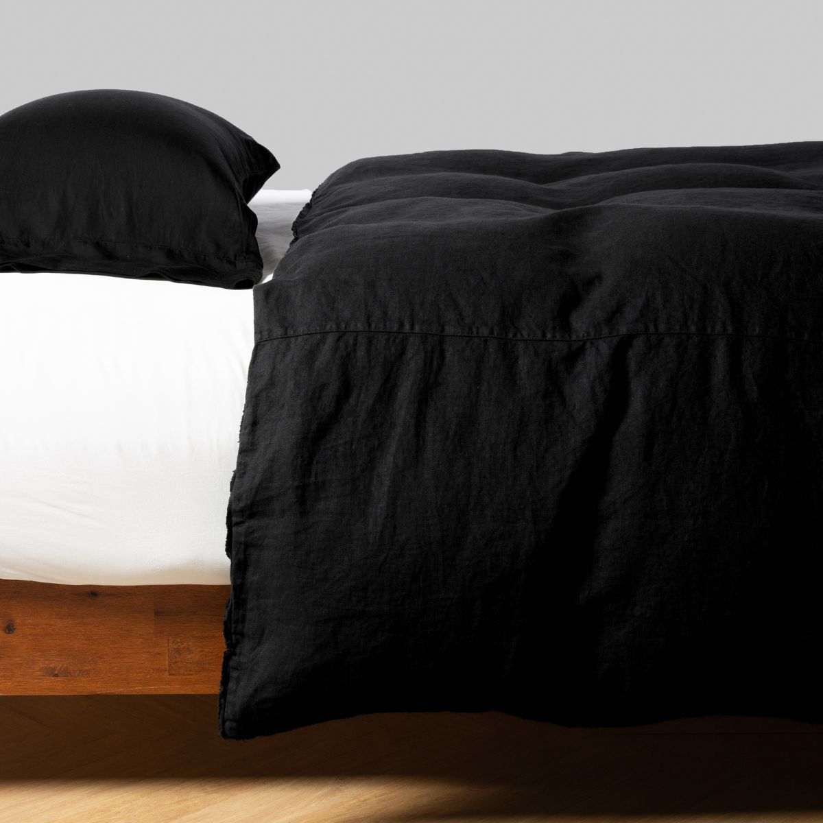 Bella Notte Austin duvet cover in Corvino draped over bed with matching pillow sham.