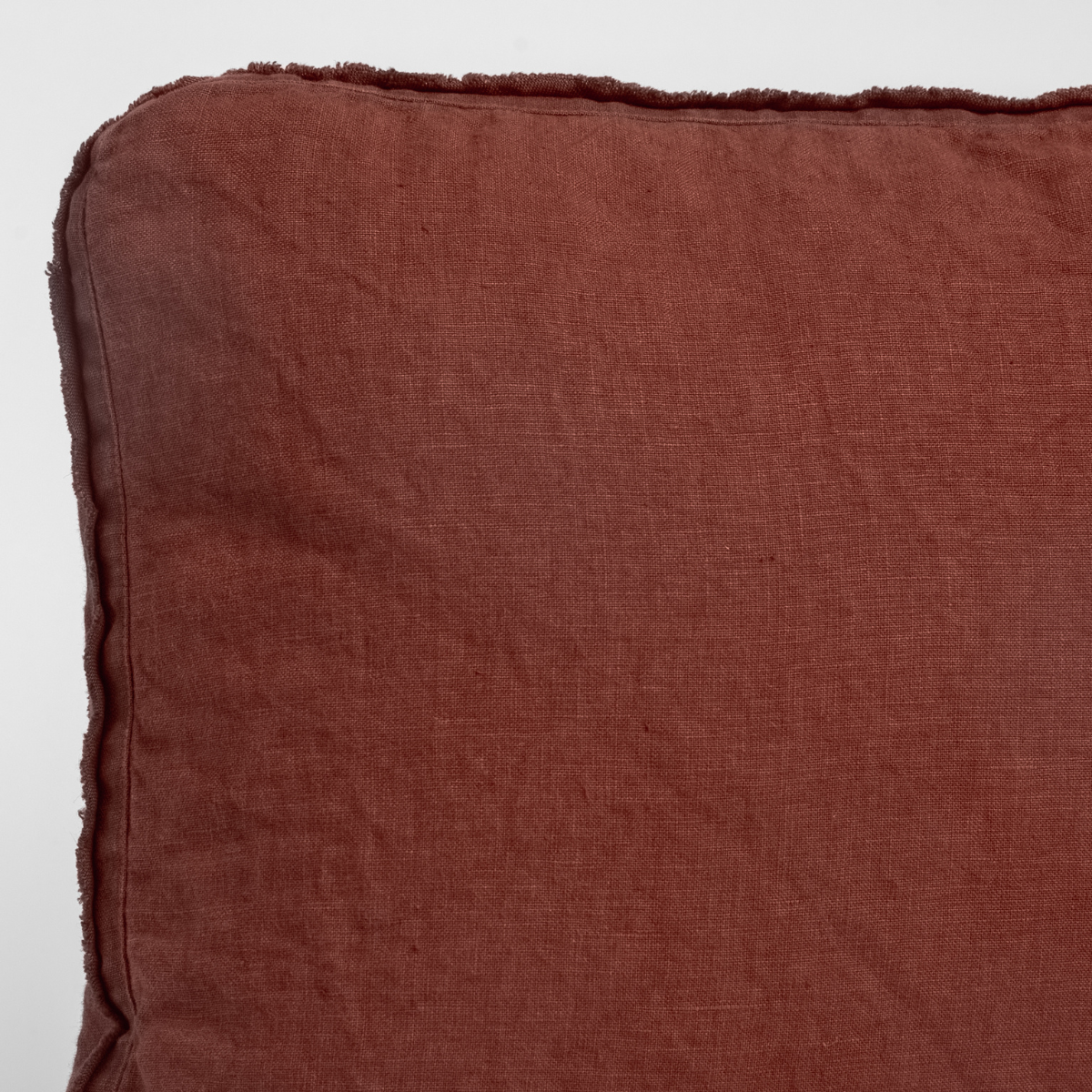 Close-up of Bella Notte Austin sham corner in Autumn, showing frayed linen edge trim.