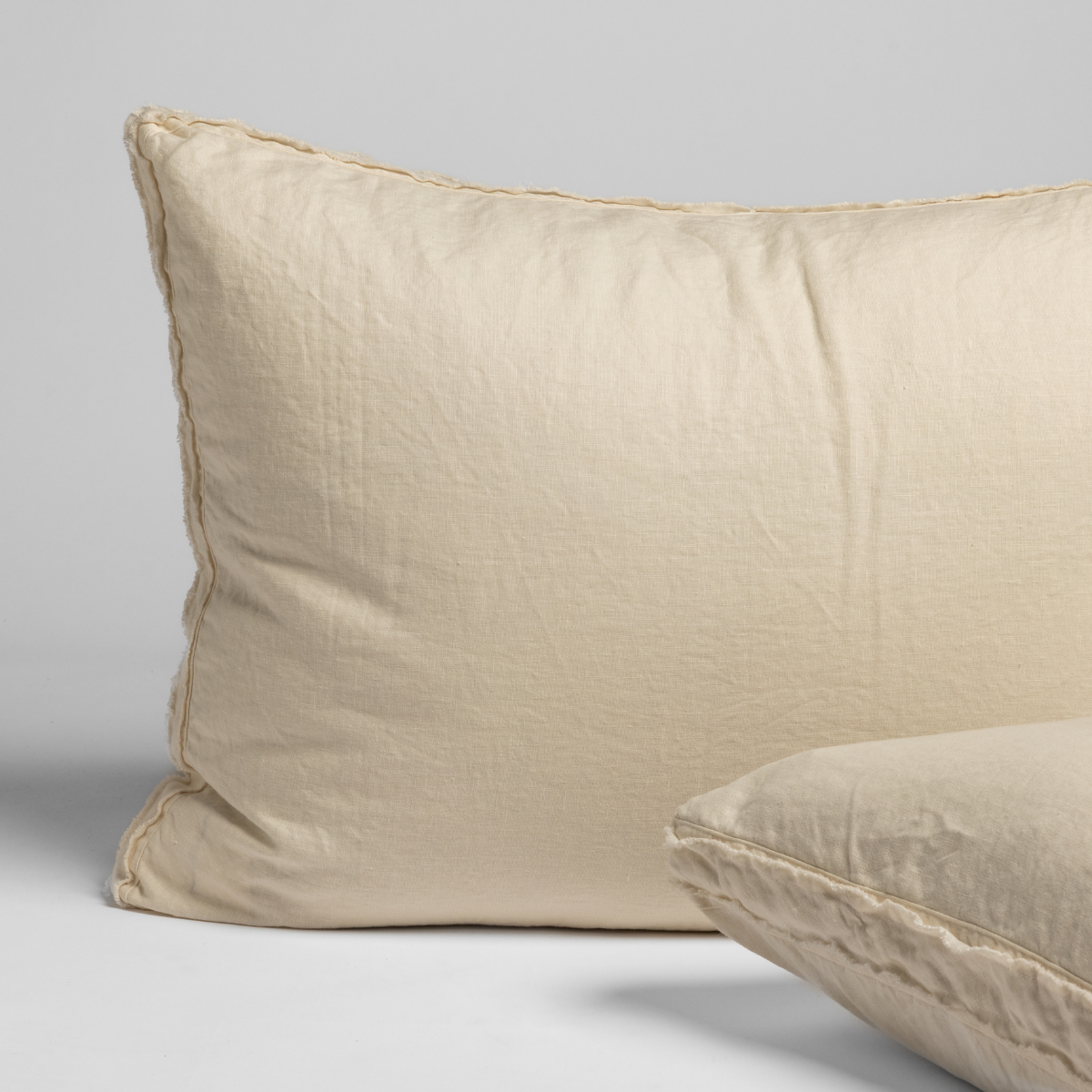 Close-up of Austin sham in Natural, showing relaxed linen texture and stitched border detail.