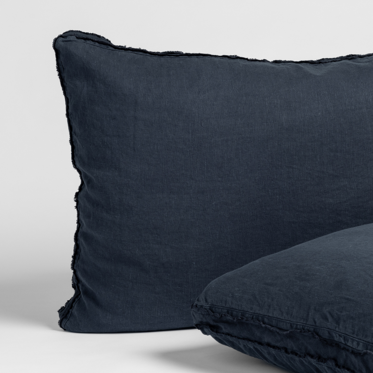 Close-up of Bella Notte Austin sham in Slate linen with frayed edge trim detail.