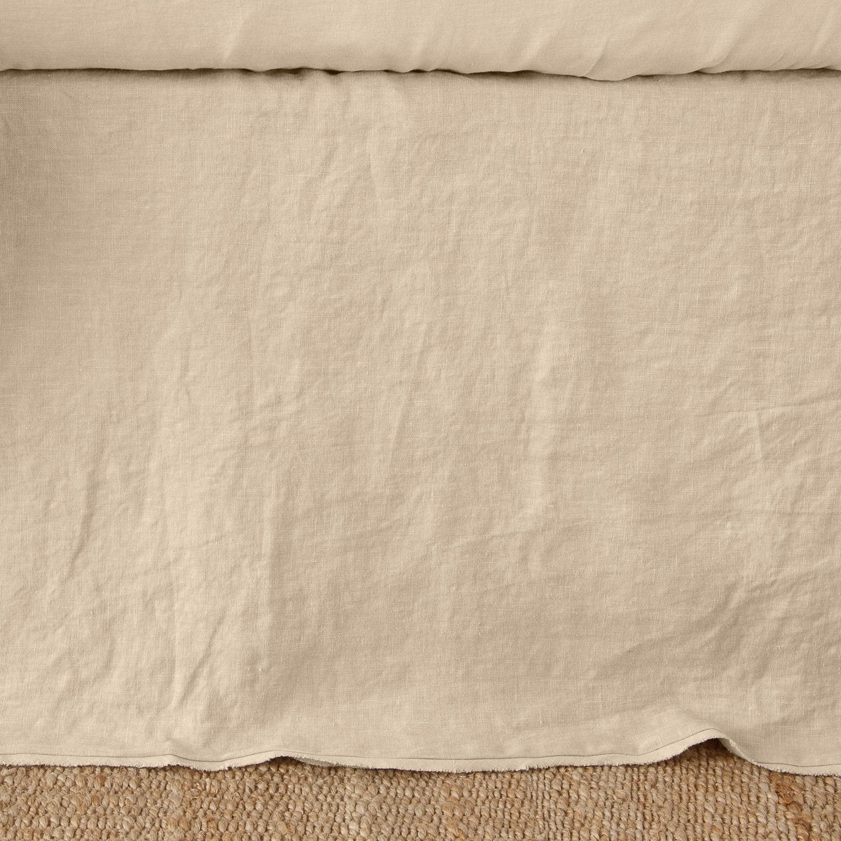 Bella Notte Austin bed skirt in Honeycomb, relaxed linen draping to floor, overhead view.