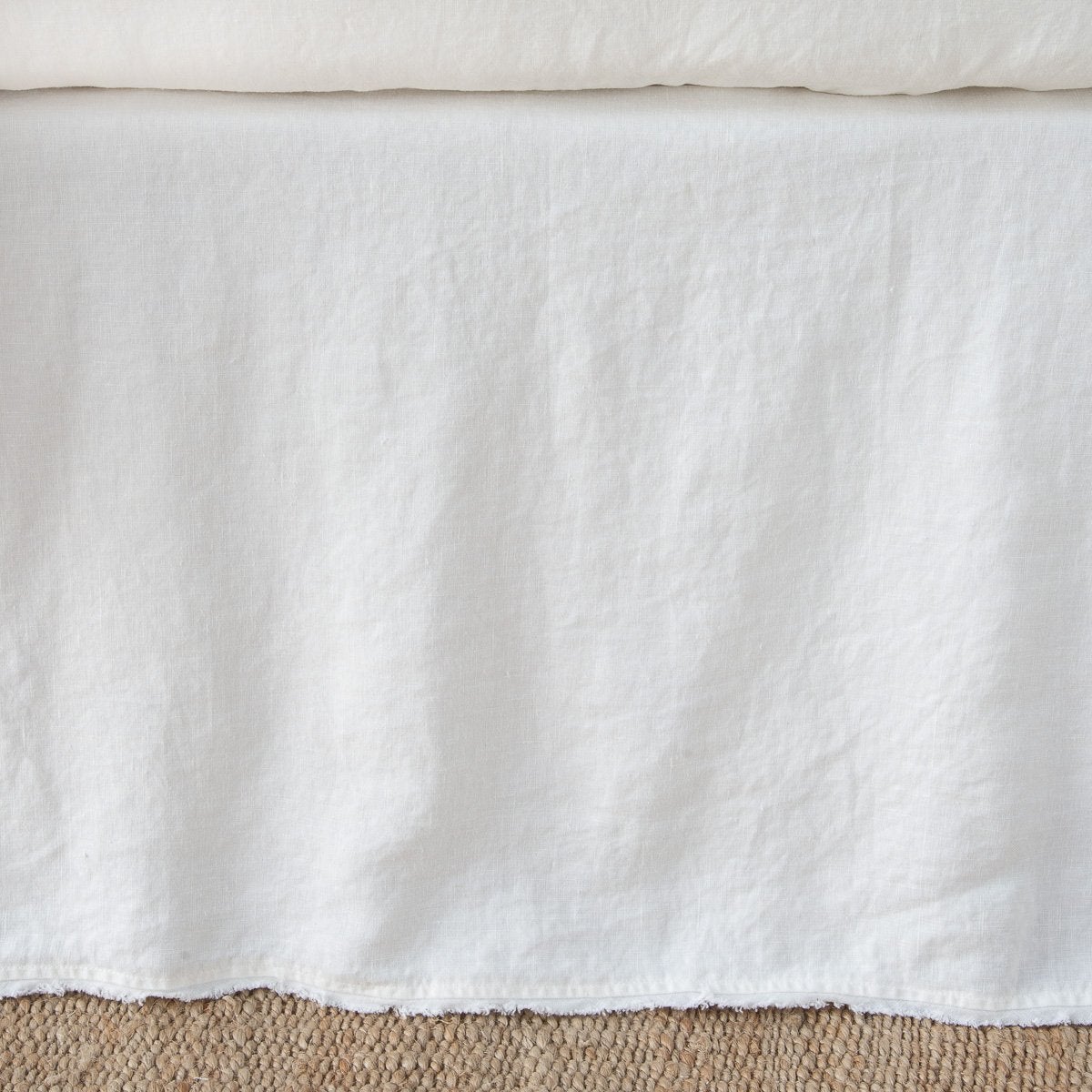 Bella Notte Austin bed skirt in Winter White, relaxed linen drape with natural texture.