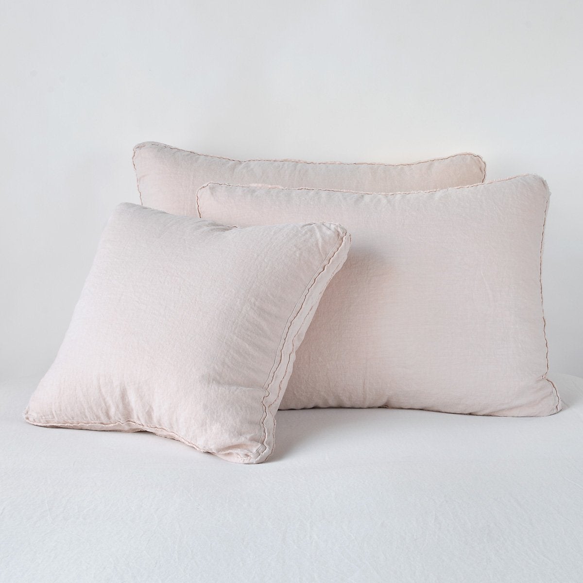 Pearl linen Austin shams stacked, showing flange edge detail in two sizes.