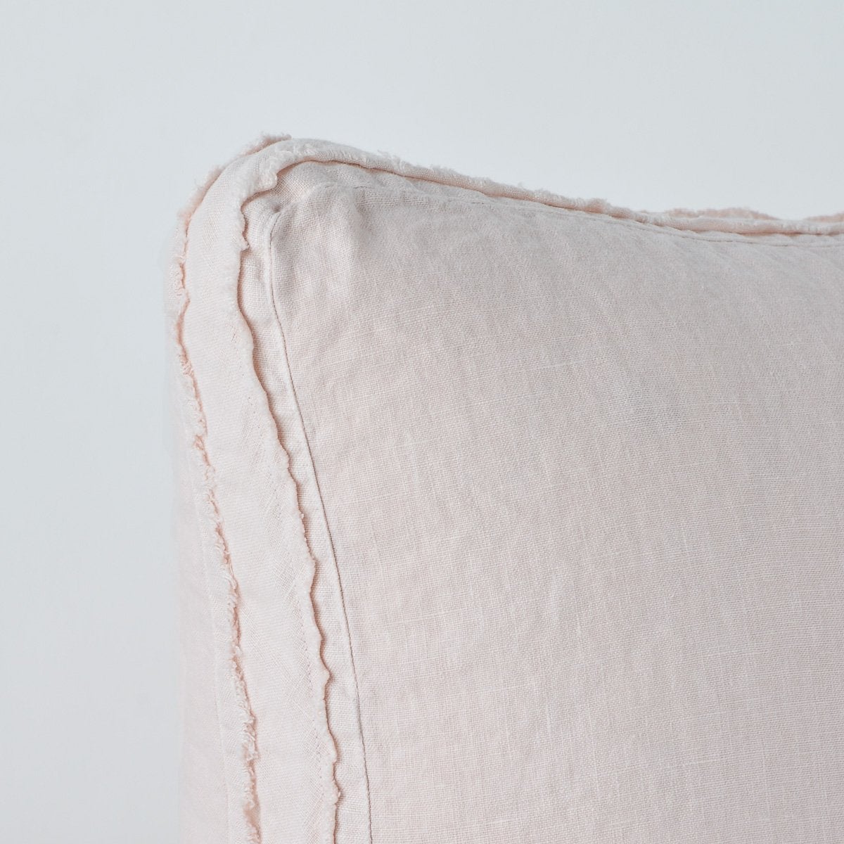 Close-up of Pearl Austin sham corner showing frayed linen edge trim detail.