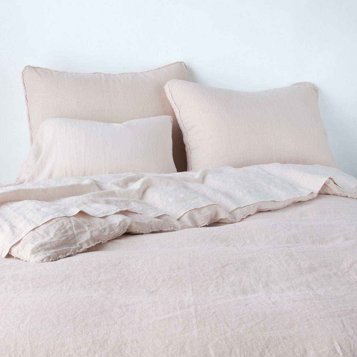 Pearl Austin sham by Bella Notte, shown with matching linen bedding in a soft bedroom styling.