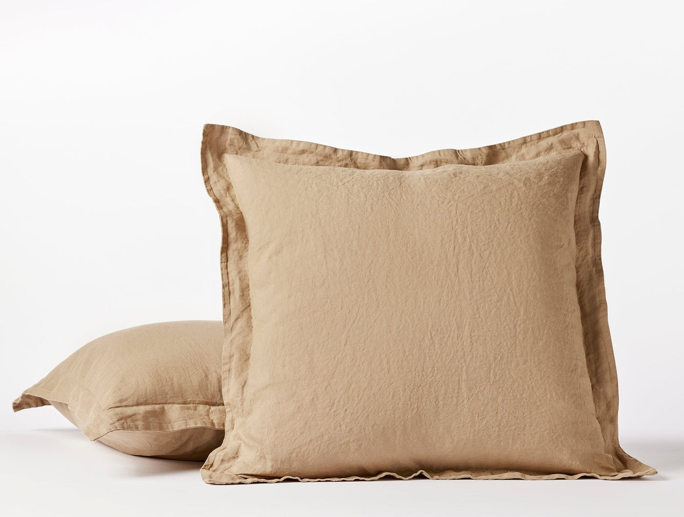 Two Coyuchi Relaxed Linen shams in camel, stacked and styled against a white background.