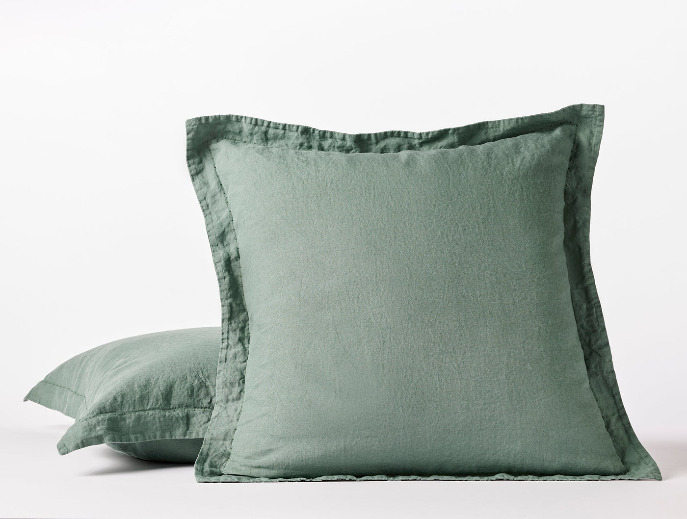 Sage green linen pillow sham with double-flange border, shown front and side view.
