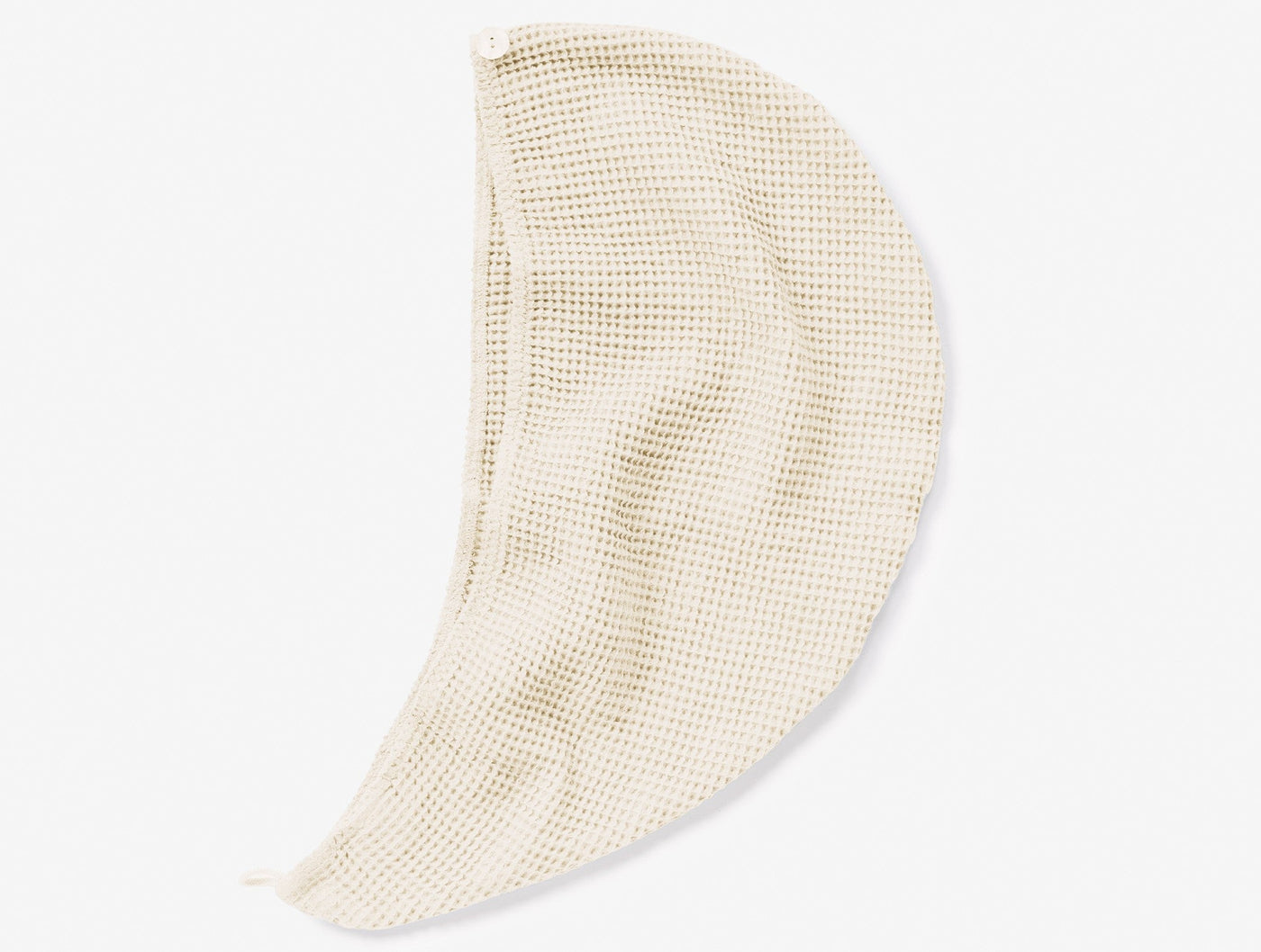 Close-up of Coyuchi Waffle hair wrap in natural, showing open-weave waffle texture and draped form.