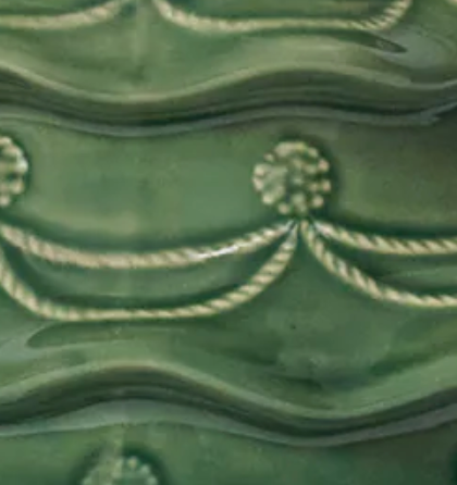 Close-up of Juliska Christmas Tree Cookie Jar in forest green glazed ceramic with rope swag relief detail.