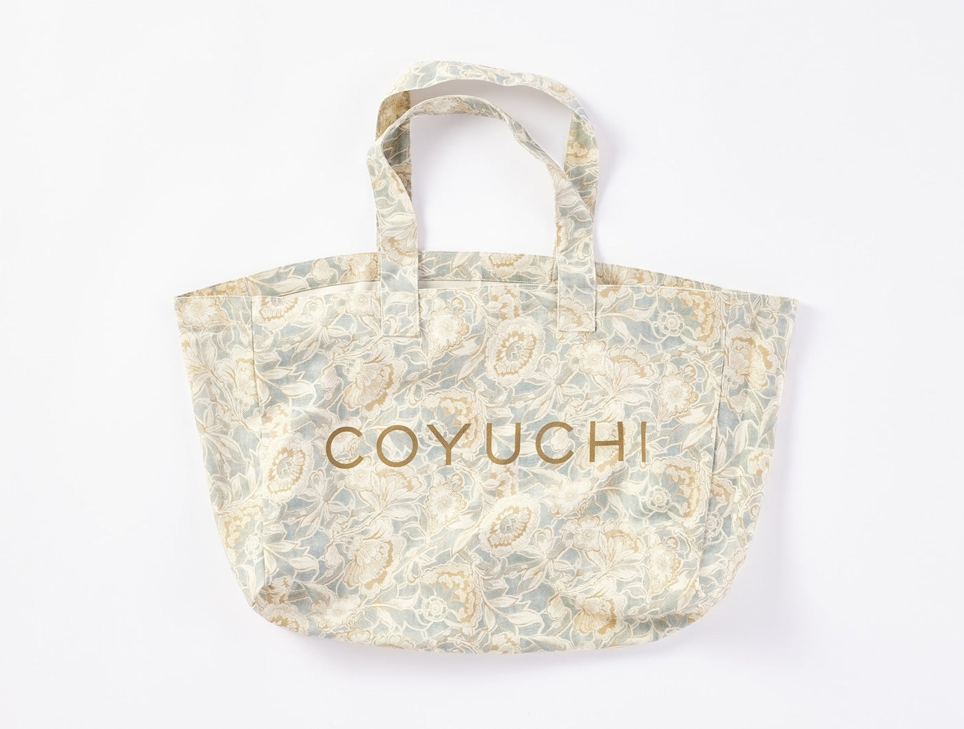 Coyuchi Balboa Print tote bag in sage and ivory floral pattern with gold embroidered logo.