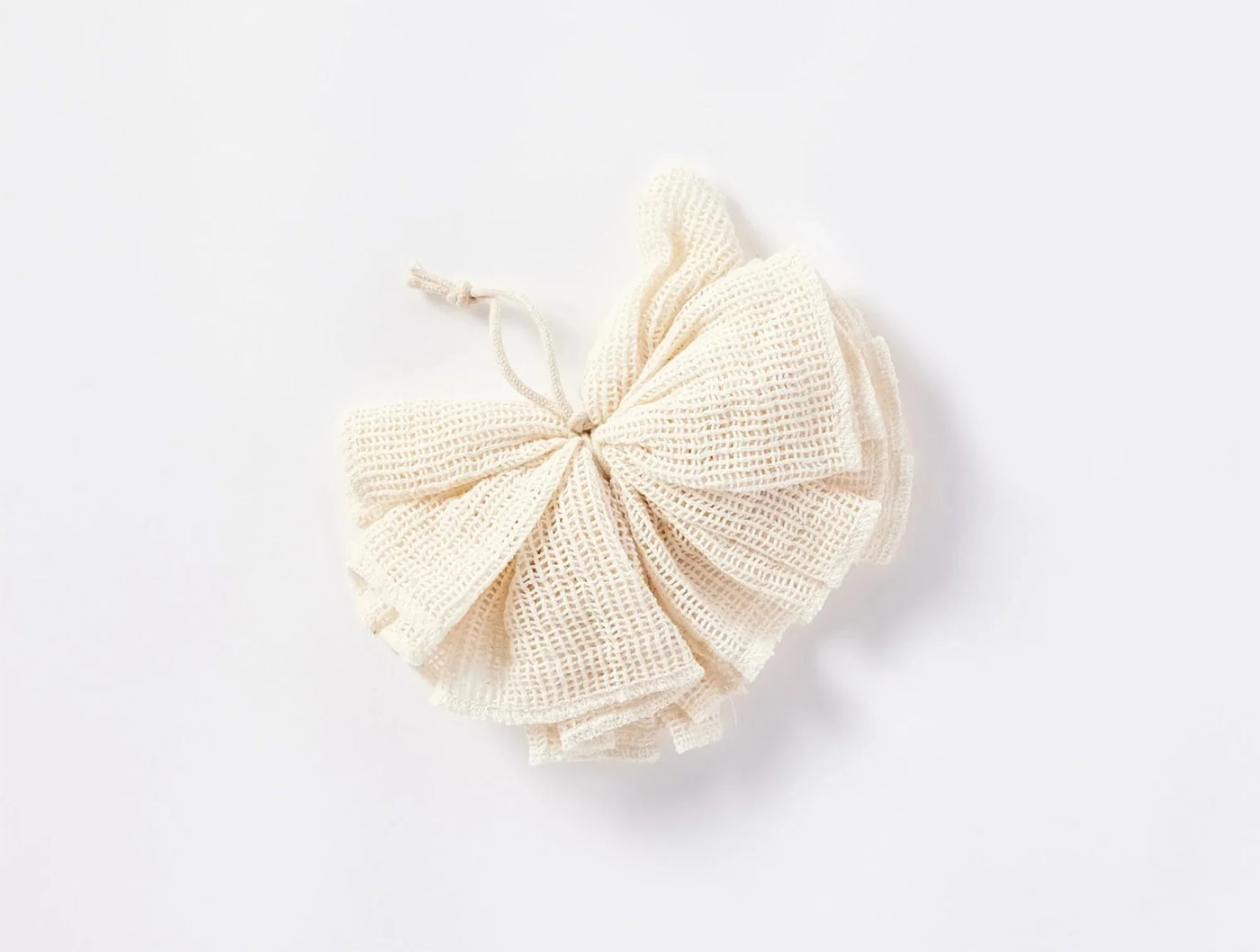 Coyuchi Bare Loofah in natural ivory, gathered cotton mesh puff with bow tie.