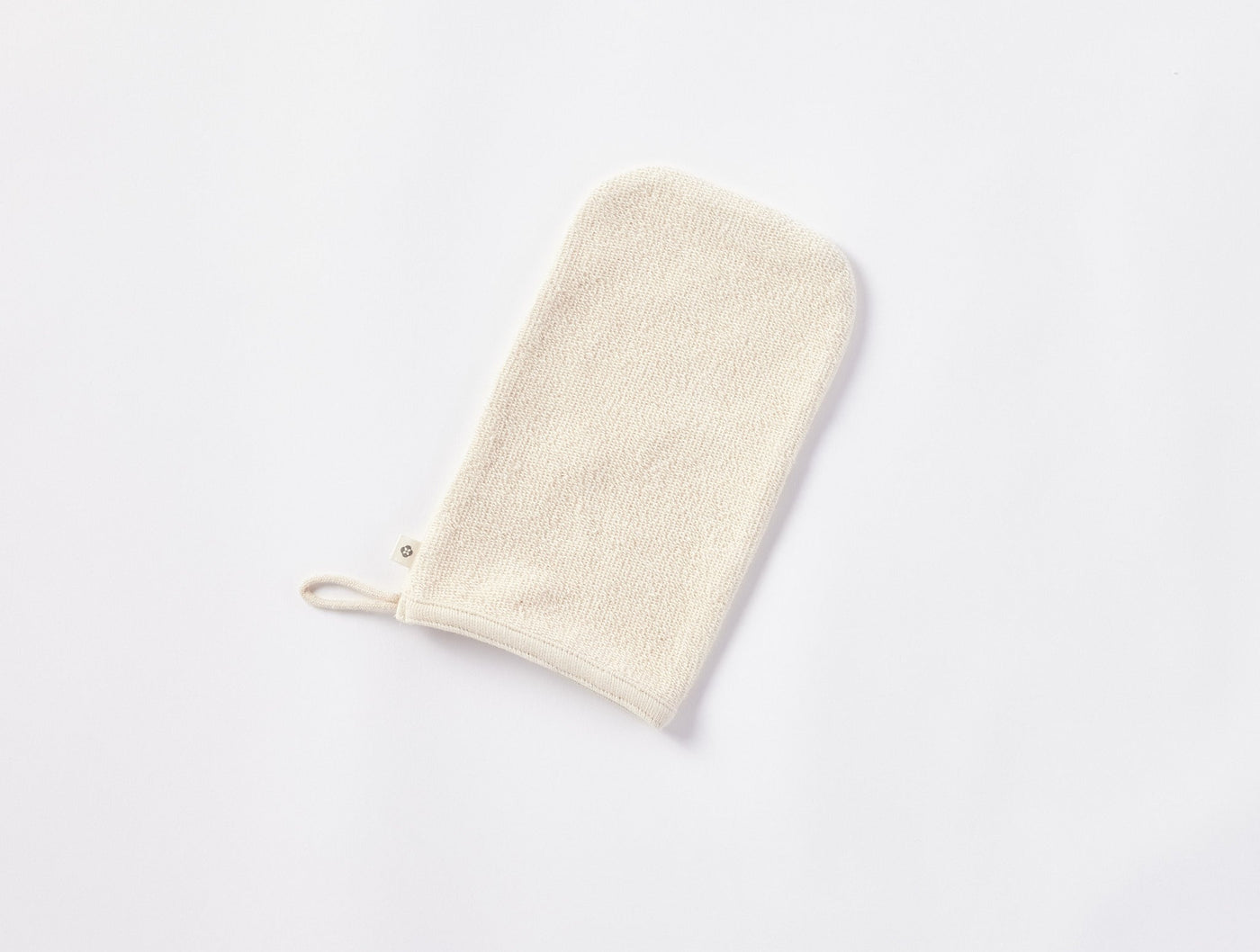 Coyuchi Bare bath mitt in undyed natural terry, shown flat with hanging loop.