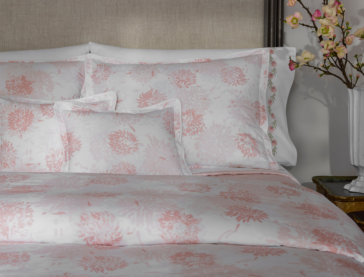 Angled view of blush floral jacquard pattern across duvet and matching shams.