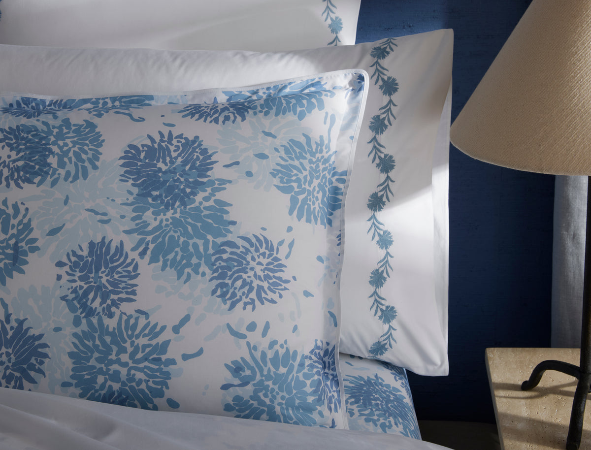 Close-up of Matouk Chrysanthemum sham flange with delicate blue vine border detail.