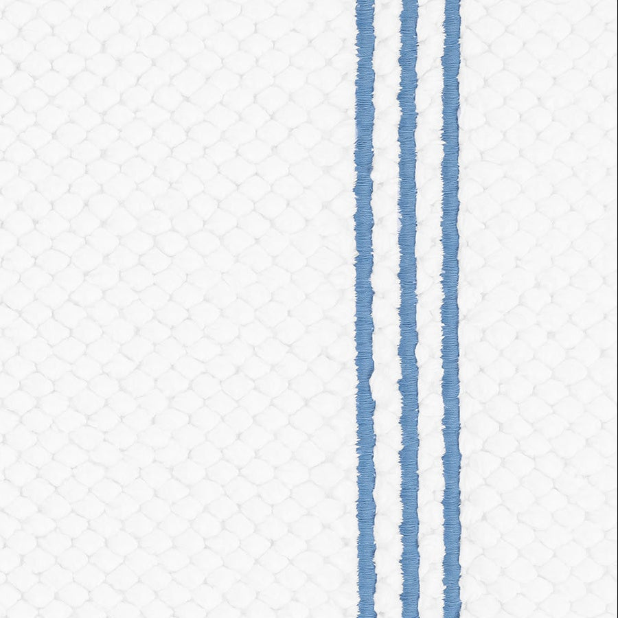Close-up of Matouk Bel Tempo bath rug showing cornflower blue stripe detail on white waffle weave.