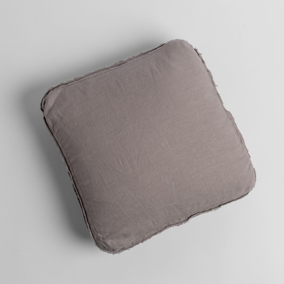 Bella Notte Austin throw pillow in Fog, overhead view showing frayed linen edges.