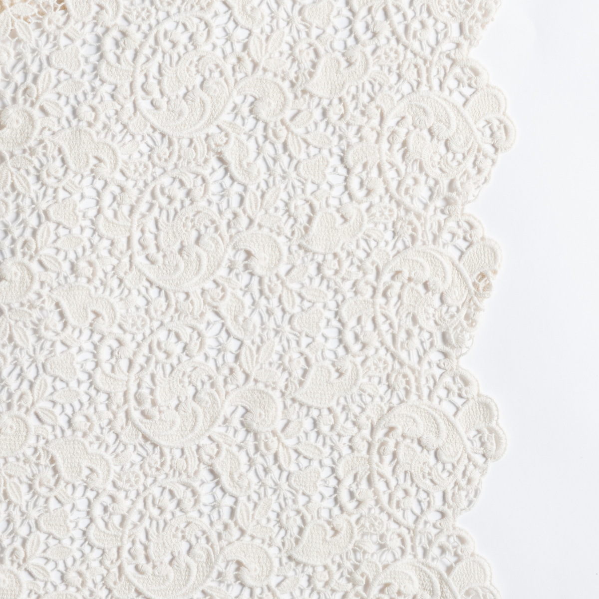 Close-up of Natural lace throw pillow showing intricate floral pattern and scalloped edge.