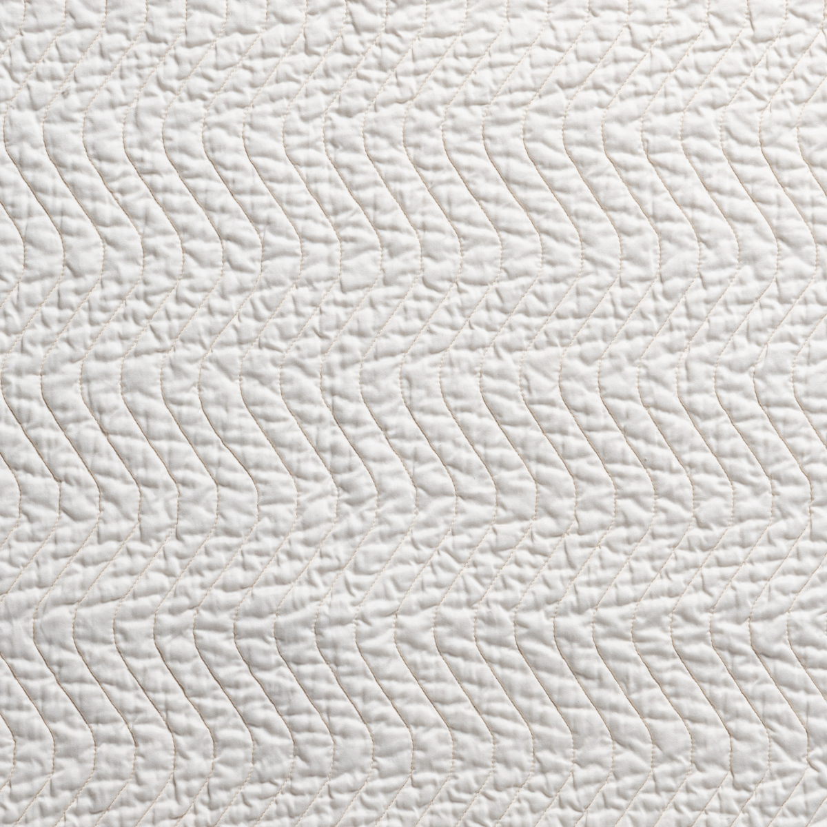 Close-up of Bella Notte Cirillo throw pillow in Natural, showing wave-quilted texture detail.