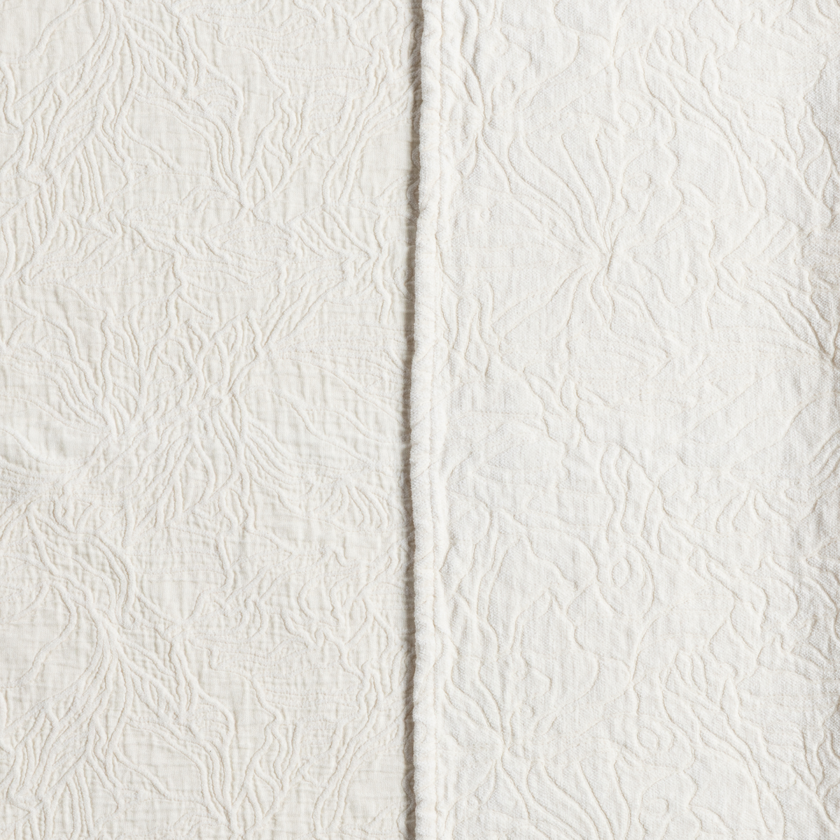 Close-up of Bella Notte Georgia pillow in Natural, showing embossed floral texture and seam detail.