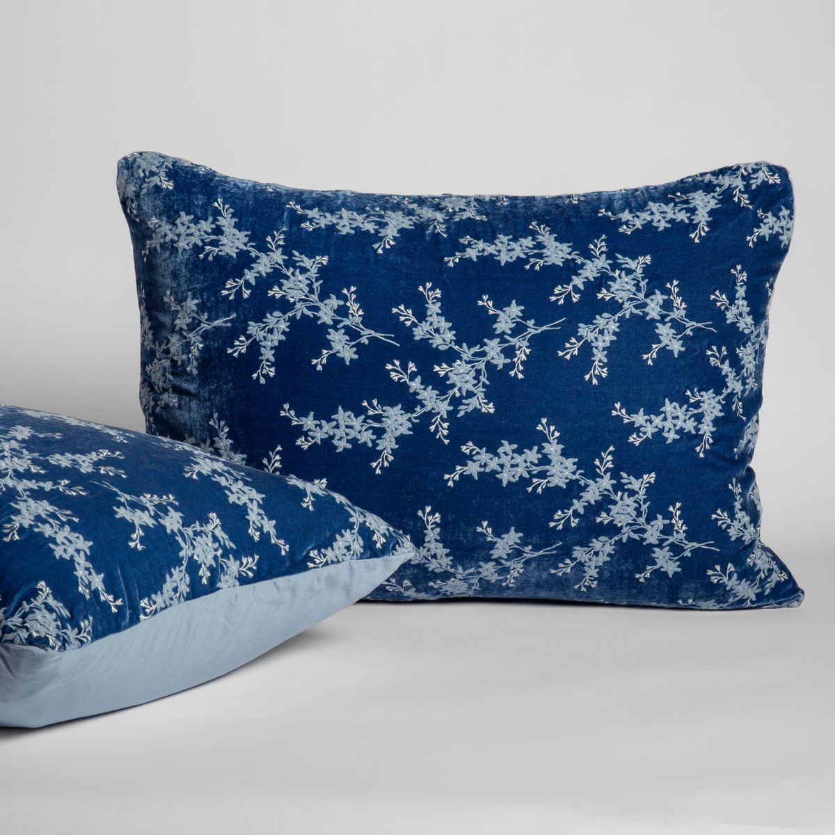 Tahoe Blue velvet shams with pale blue floral embroidery, front and reverse shown.