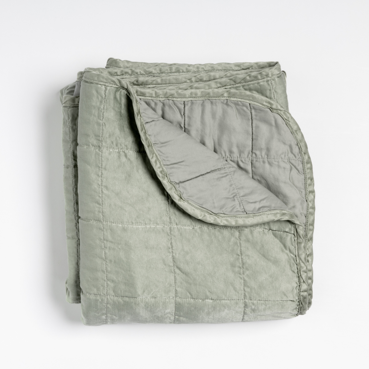 Corner fold detail revealing lighter reverse side of Bella Notte Sel blanket in Eucalyptus.