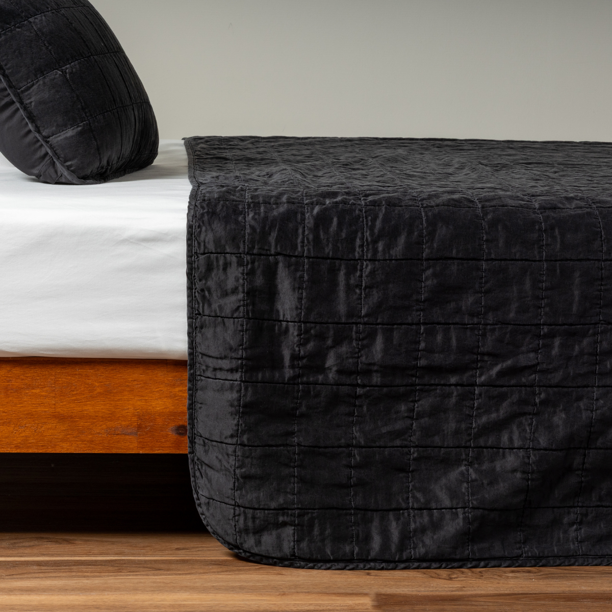 Foot-of-bed view of Bella Notte Sel coverlet in Corvino, showing quilted channel stitching detail.