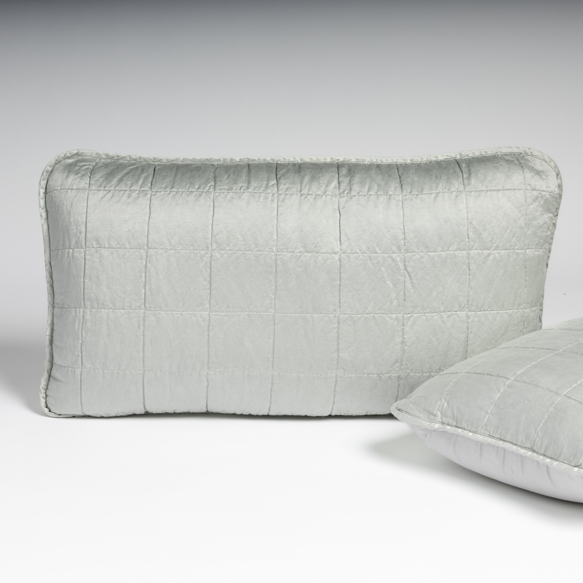 Bella Notte Sel sham in Cloud, showing quilted grid stitching and fringe trim detail.