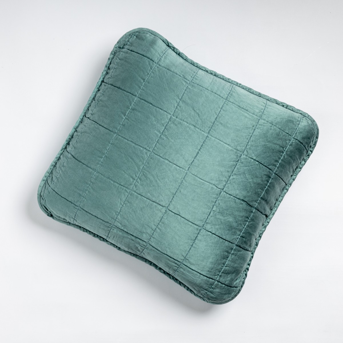 Bella Notte Sel throw pillow in Cenote, quilted velvet with grid stitching and flanged edge.