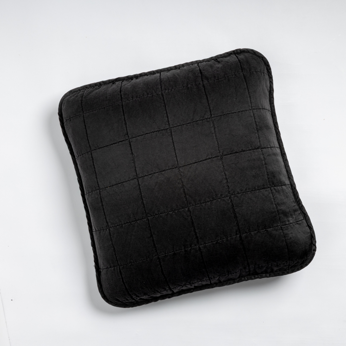 Corvino velvet throw pillow with grid quilting and flanged edge, close-up front view.