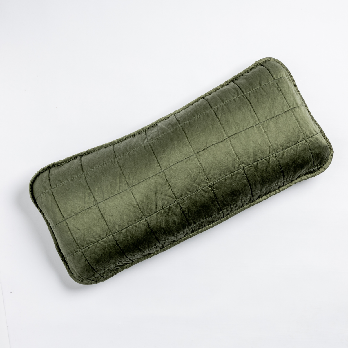 Juniper velvet lumbar throw pillow with quilted grid stitching, angled top view.