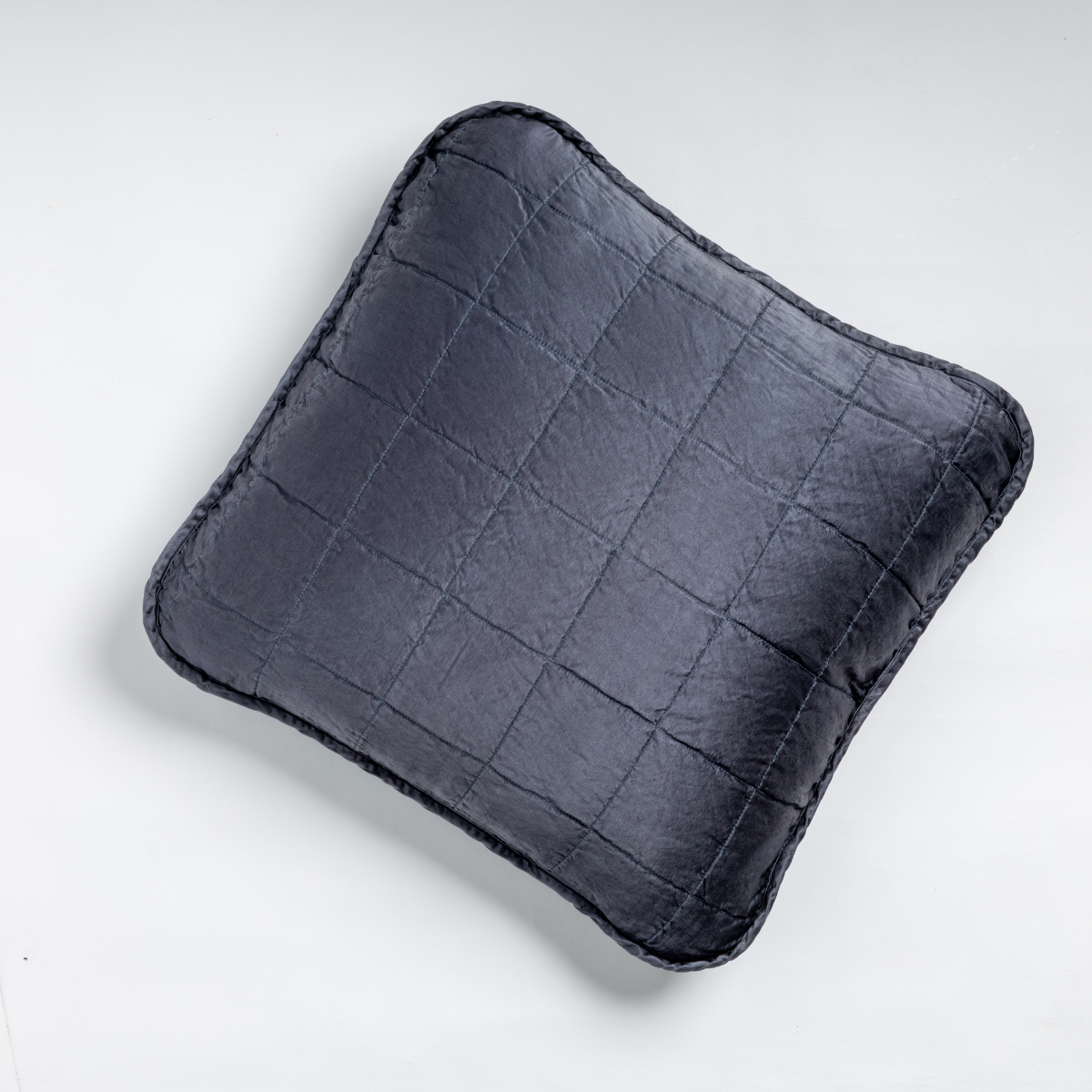 Midnight Sel throw pillow close-up showing quilted grid pattern and contrast flange edge.