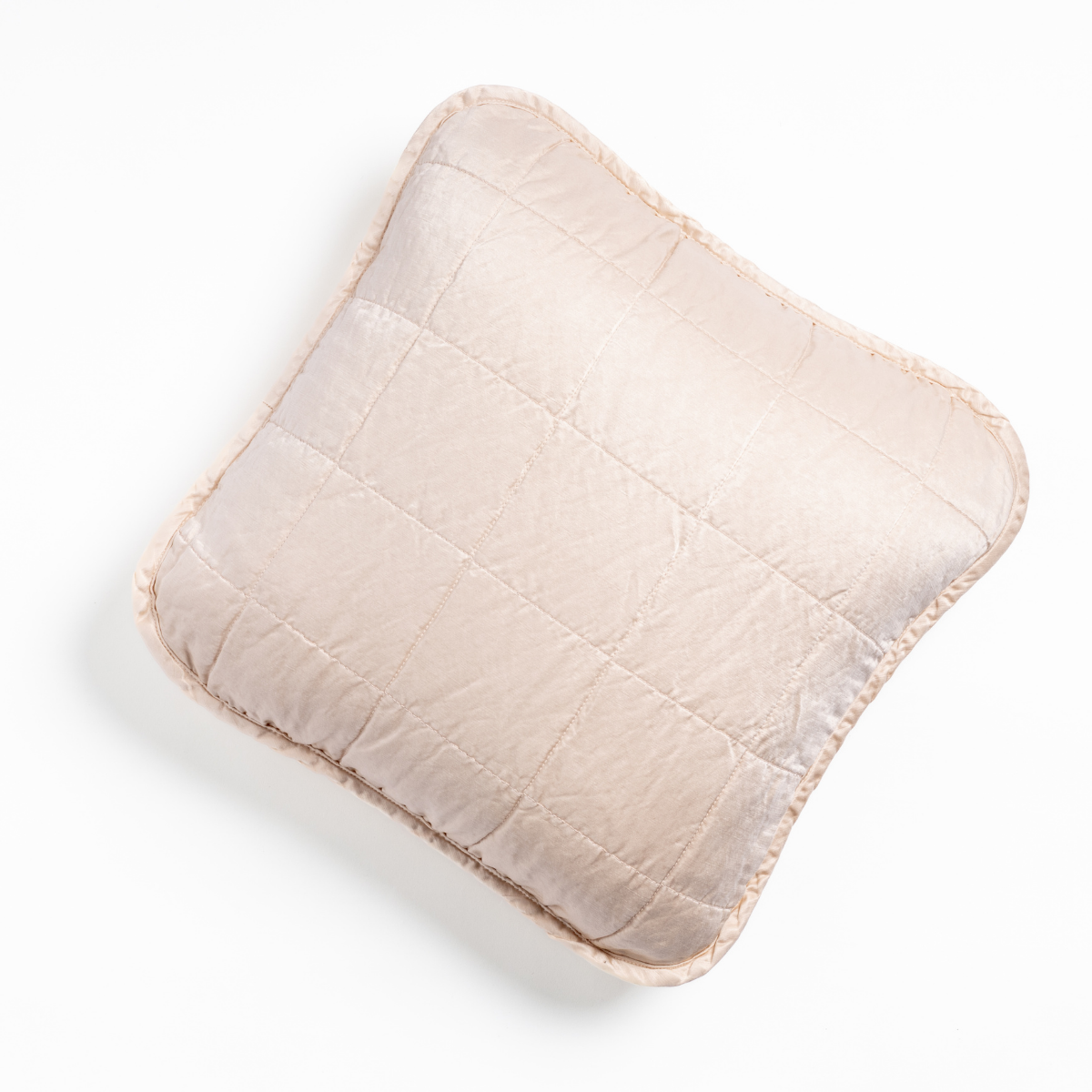 Pearl quilted Bella Notte Sel throw pillow with fringe trim, overhead view.