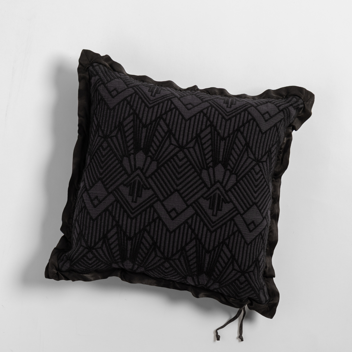 Corvino Trettino throw pillow, geometric embroidered pattern with ruffle trim and tassel detail.