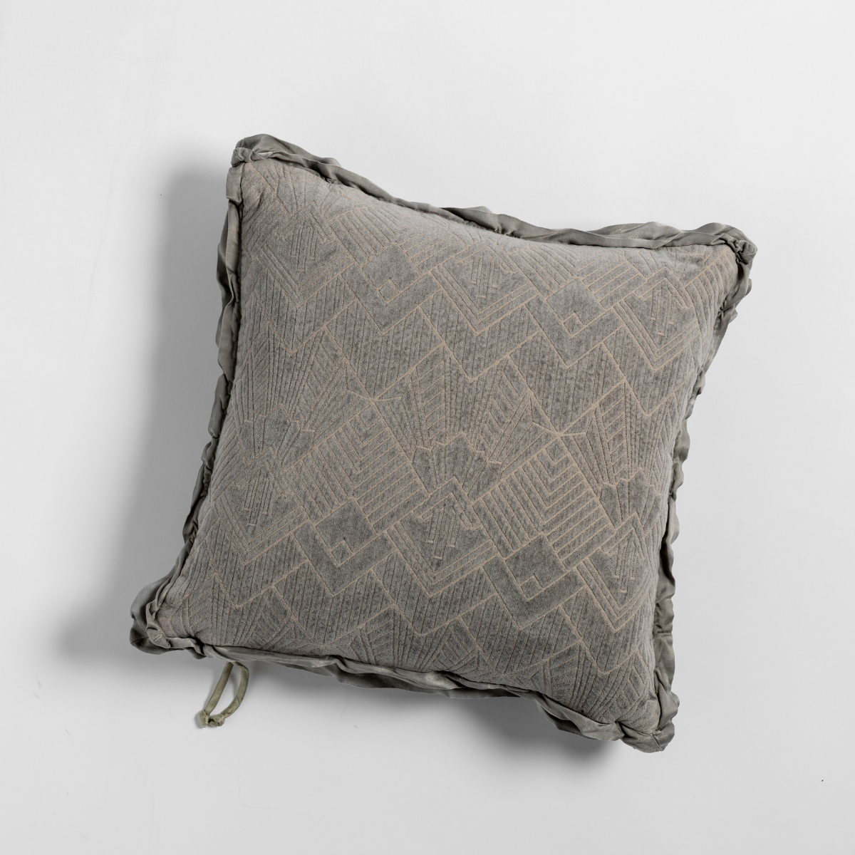 Fog Trettino throw pillow showing geometric diamond pattern and ruched ruffle trim detail.