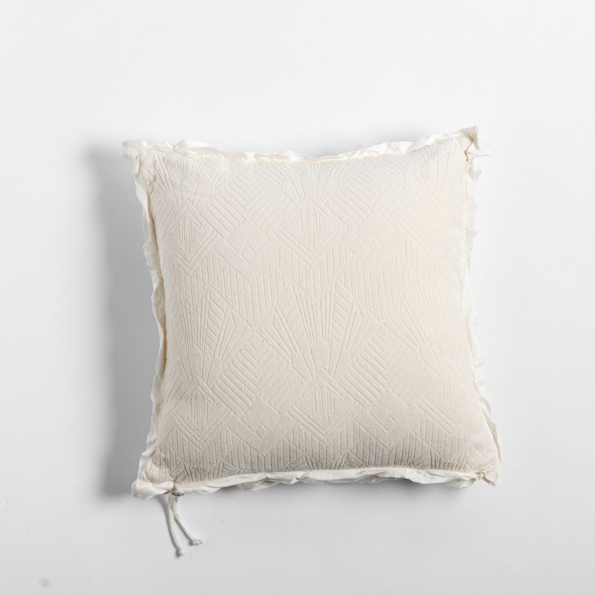 Bella Notte Trettino throw pillow in Natural, showing textured diamond quilting with fringe trim.