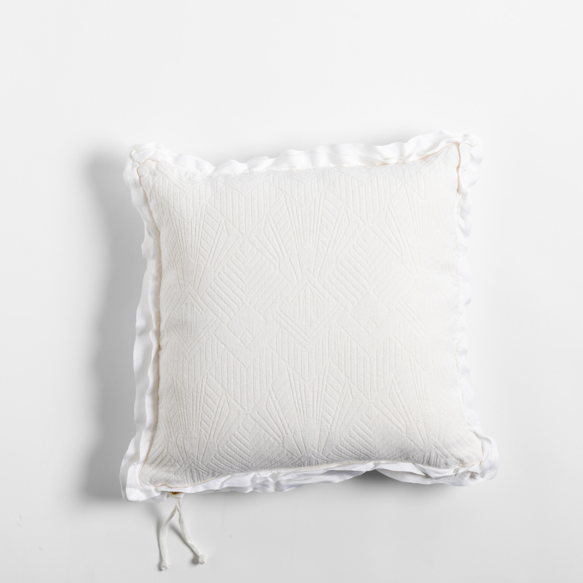 Bella Notte Trettino throw pillow in Winter White with quilted texture and ruffled edge trim.