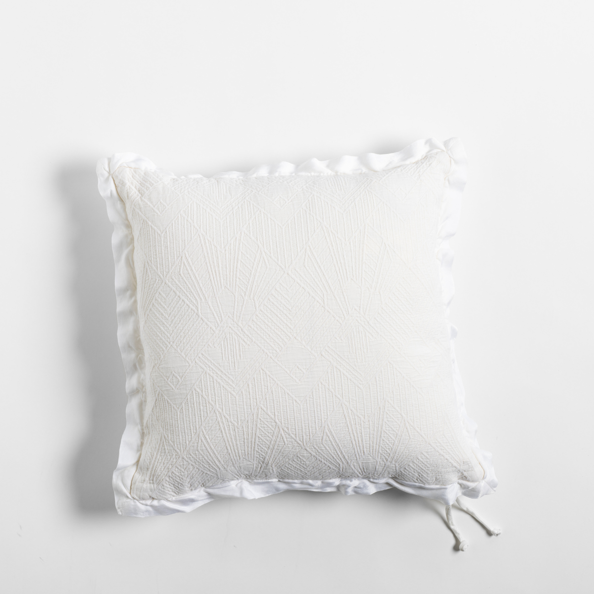 Bella Notte Trettino throw pillow in Winter White with textured matelassé and ruffled trim detail.
