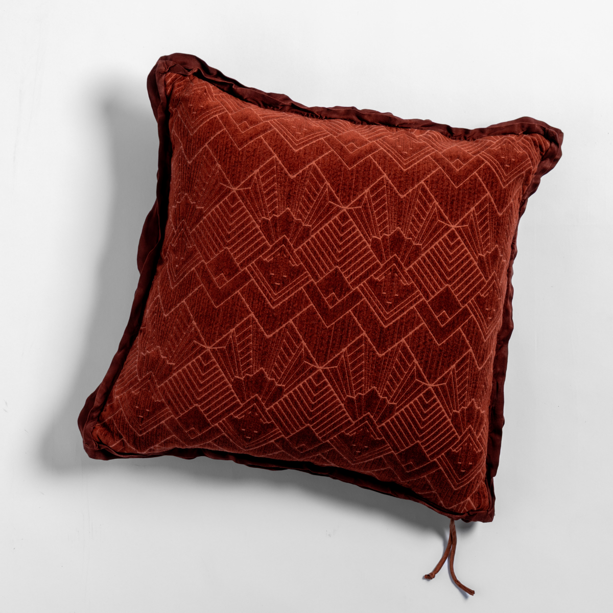 Bella Notte Trettino pillow in Autumn, close-up of geometric chevron velvet texture with cord trim.