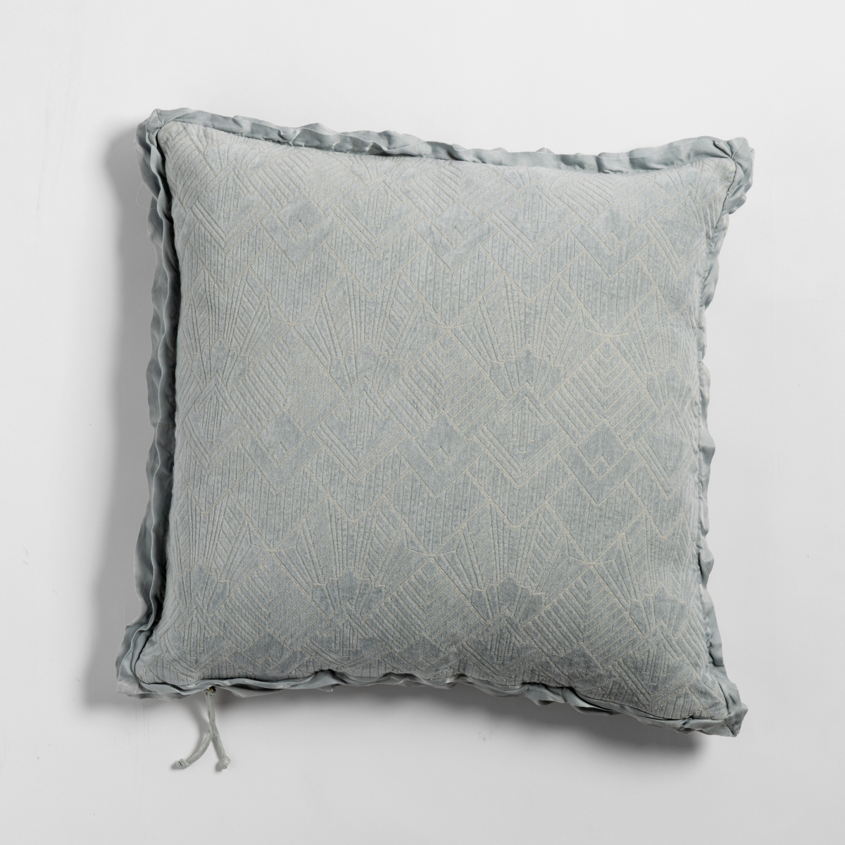 Trettino throw pillow in Cloud, showing diamond-textured fabric with ruffled trim detail.