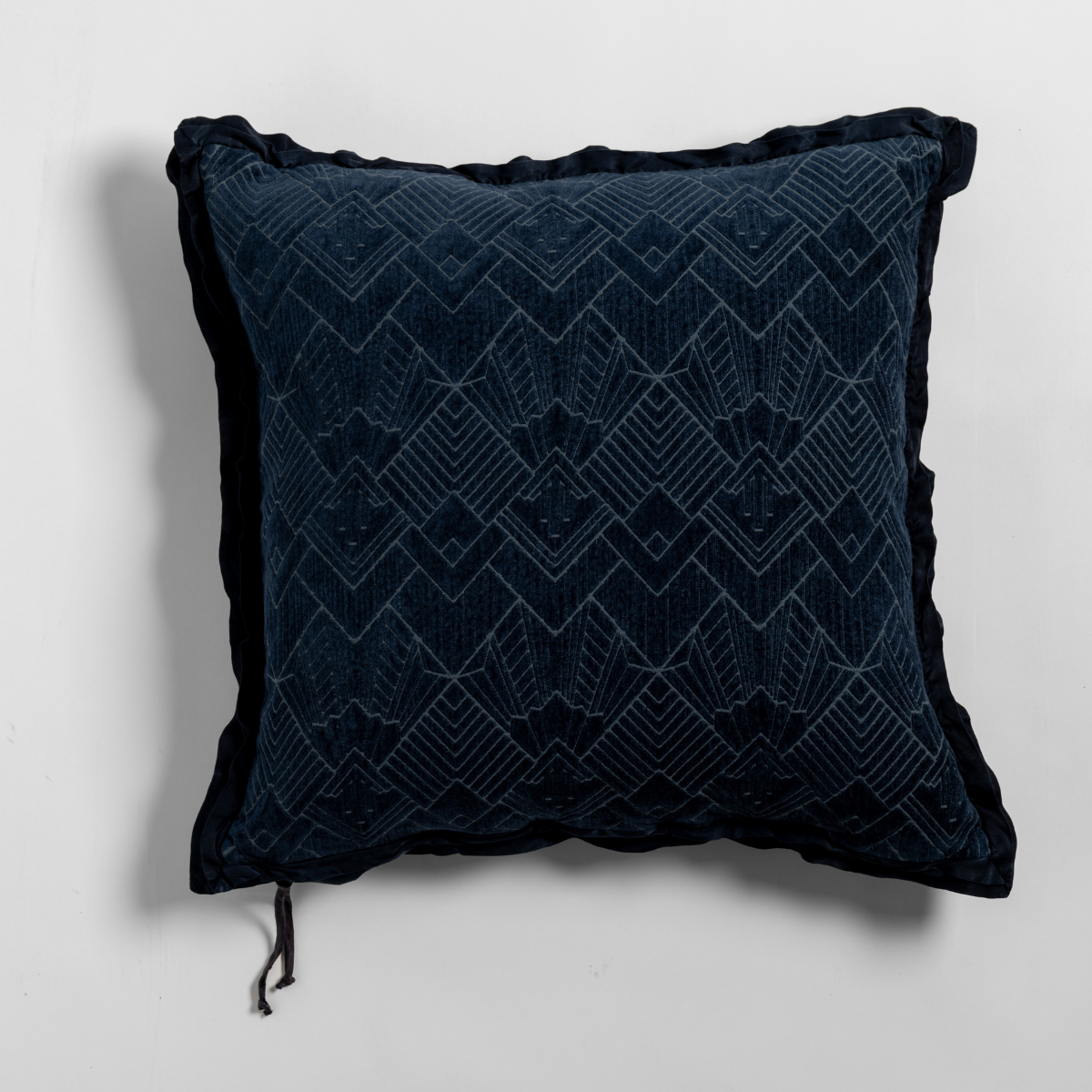Bella Notte Trettino throw pillow in Midnight velvet with geometric diamond quilted pattern and tassel trim.