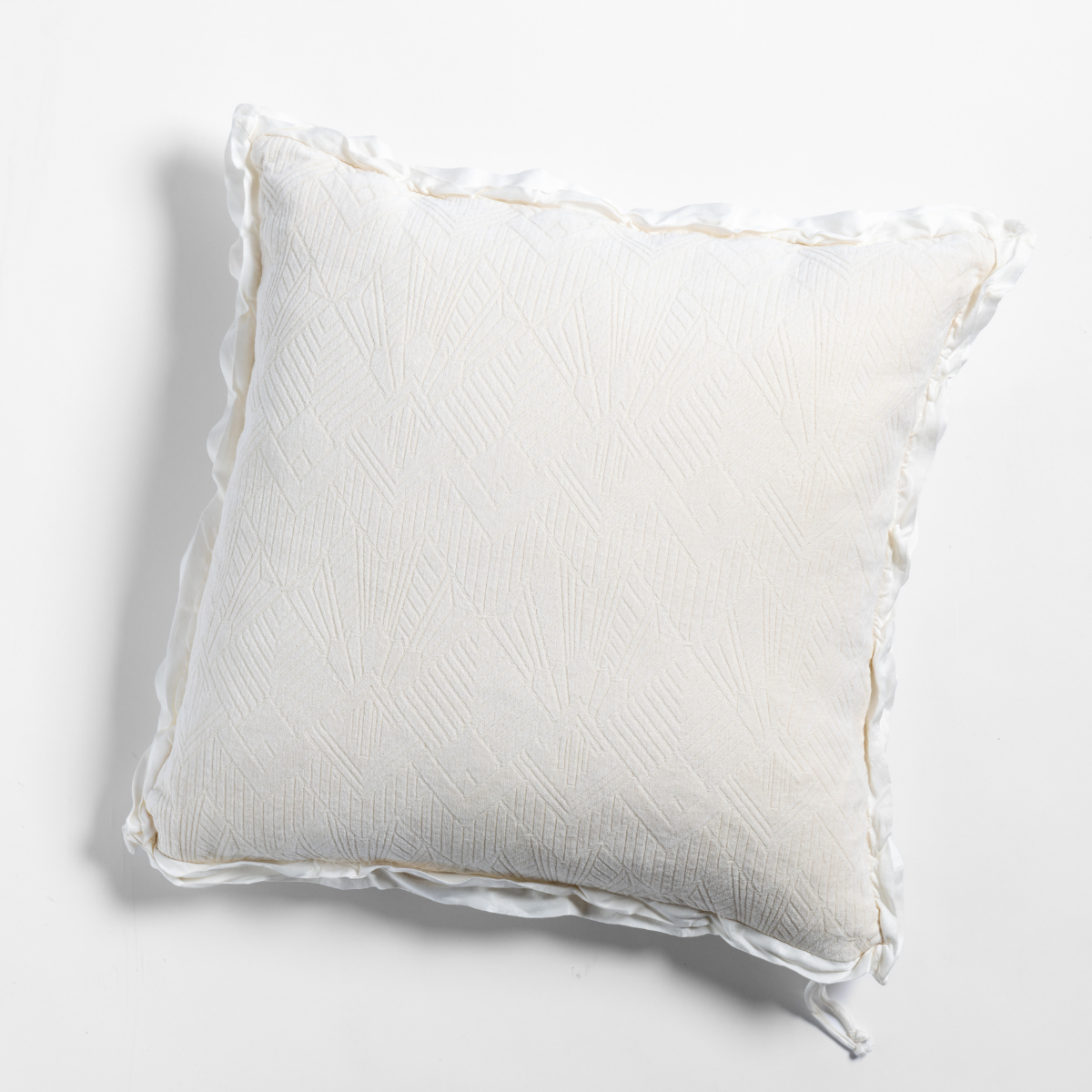 Bella Notte Trettino throw pillow in Natural, showing ruffled trim detail on light grey background.