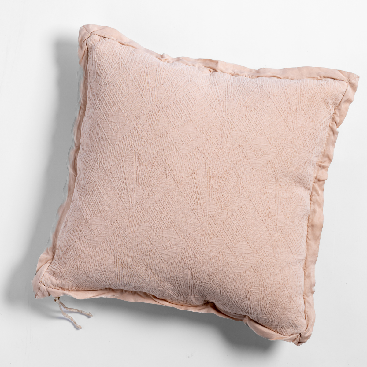 Bella Notte Trettino throw pillow in Pearl, showing textured quilted face with ruched trim detail.