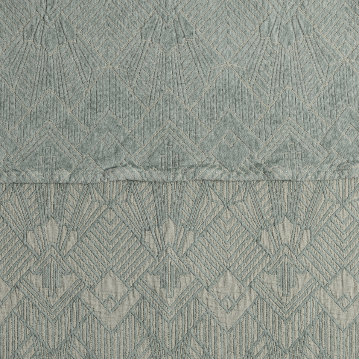 Close-up of Bella Notte Trettino bedspread in Eucalyptus, showing diamond jacquard weave and hem detail.