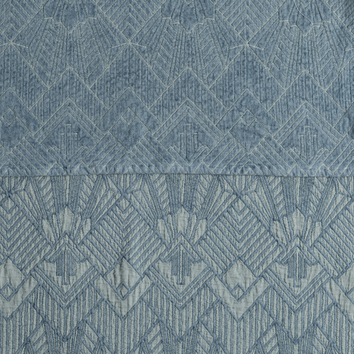 Close-up of Tahoe Blue Trettino fabric showing geometric diamond jacquard weave detail.