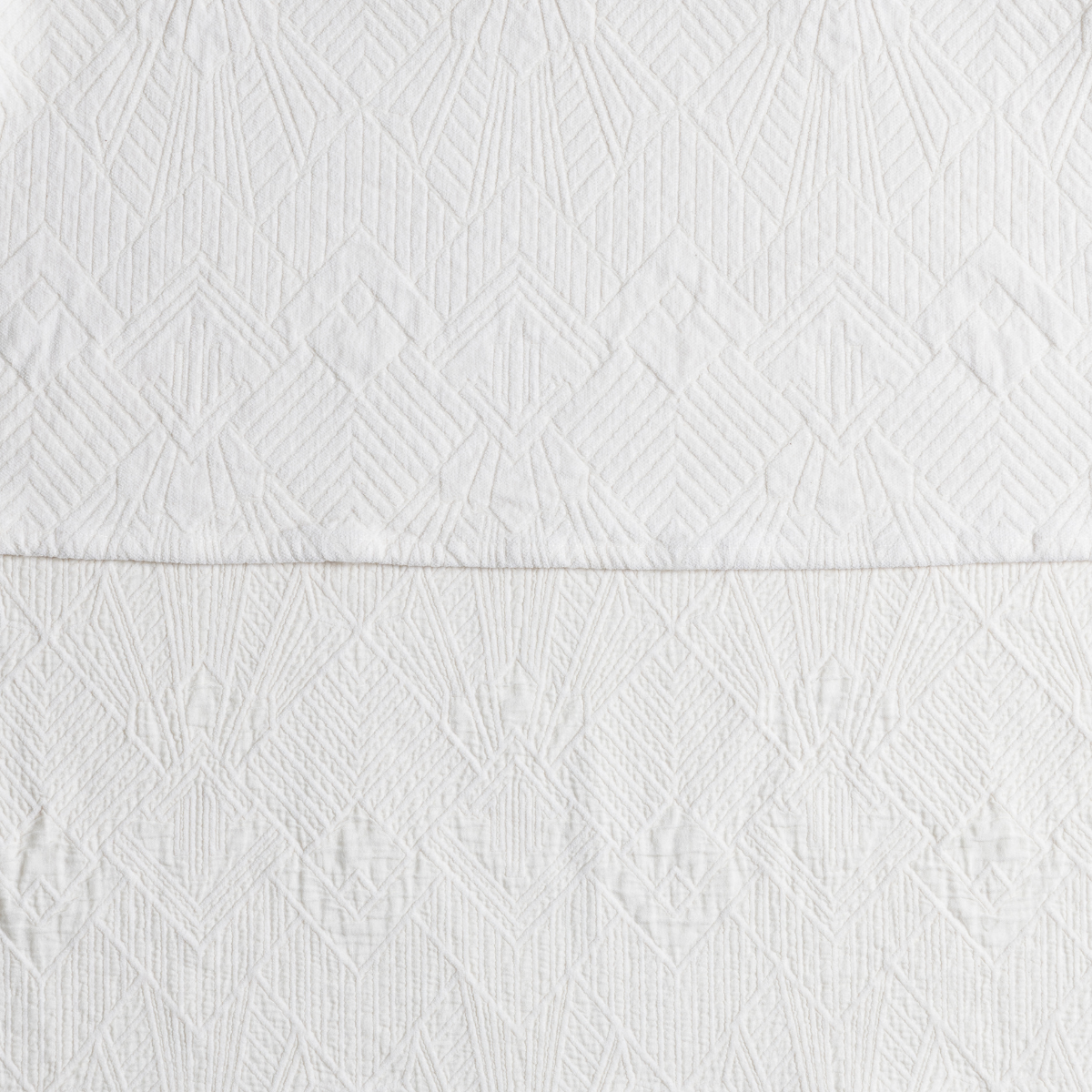 Close-up of Bella Notte Trettino sham in Winter White, showing diamond jacquard texture detail.